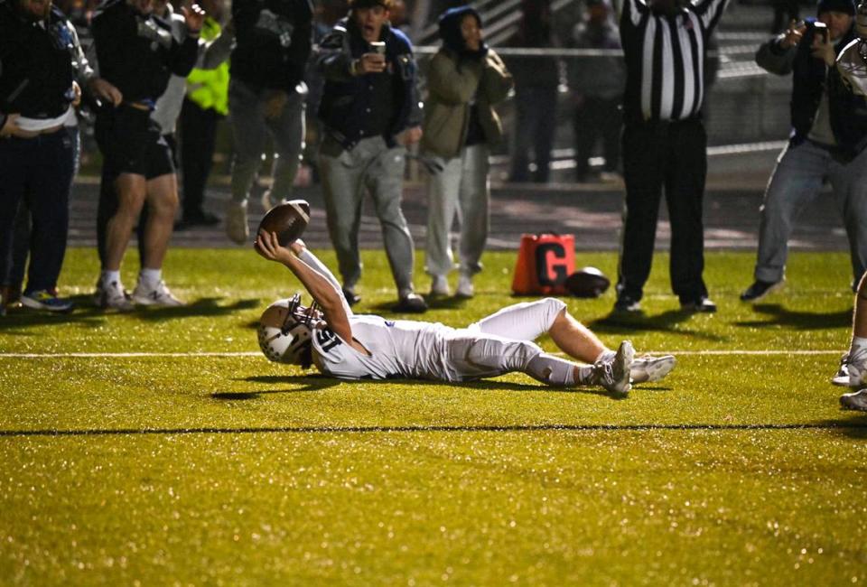 Mill Valley High School’s Daniel Blaine holds the ball aloft after scoring the game-winning touchdown as time expires against Blue Valley Southwest in the Kansas Class 5A semifinals on Friday night.