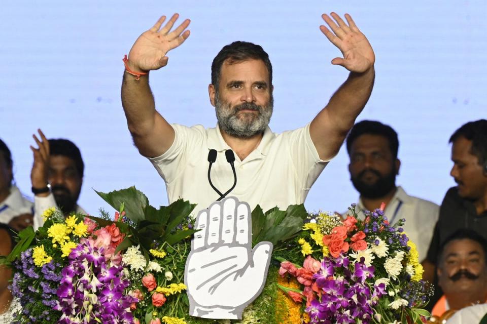 Rahul Gandhi waves to supporters during an election campaign public meeting in Rae Bareli (AFP)