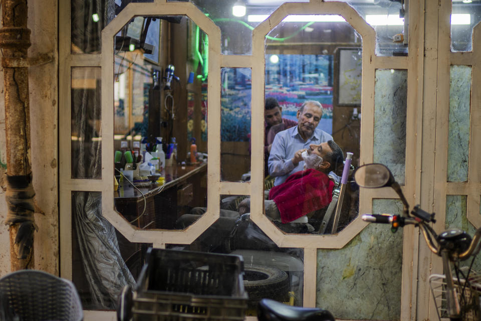 A man has his beard shaved by a barber in Fallujah, Iraq, on Thursday, March 2, 2023. (AP Photo/Jerome Delay)