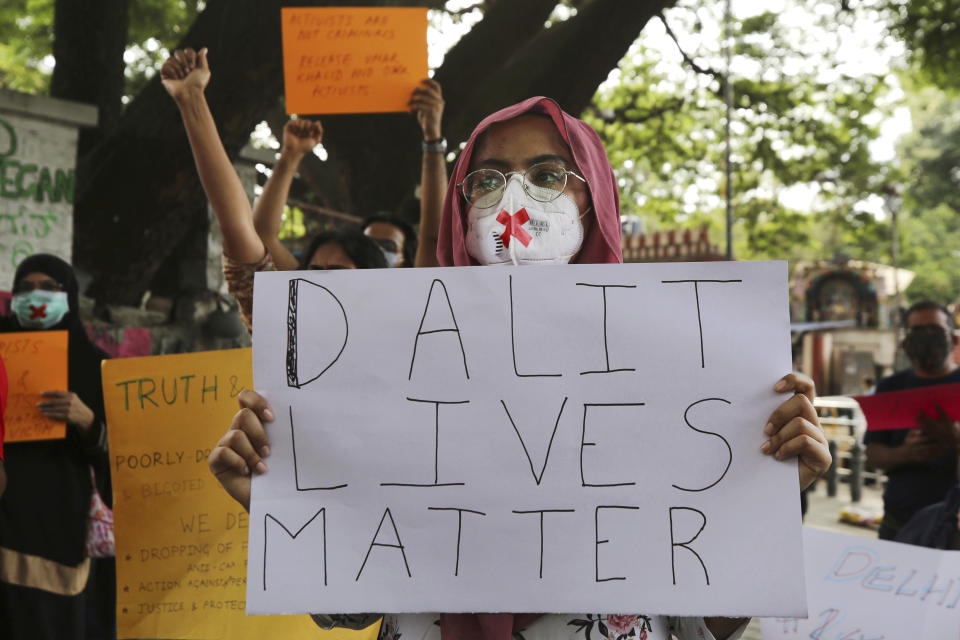 FILE - Demonstrators hold signs during a protest condemning the alleged gang rape and killing of a Dalit woman, in Bengaluru, India, Sunday, Oct. 4, 2020. Protestors have been demanding the dismissal of the government of the northern Indian state where the 19-year-old woman from the country's lowest caste was allegedly gang raped and later died in a hospital. Dalits, formerly known as "untouchables" and at the bottom of India's Hindu caste hierarchy, are victims of thousands of attacks each year. According to human rights organizations, Dalit women are particularly vulnerable to caste-based discrimination and sexual violence. (AP Photo/Aijaz Rahi, File)