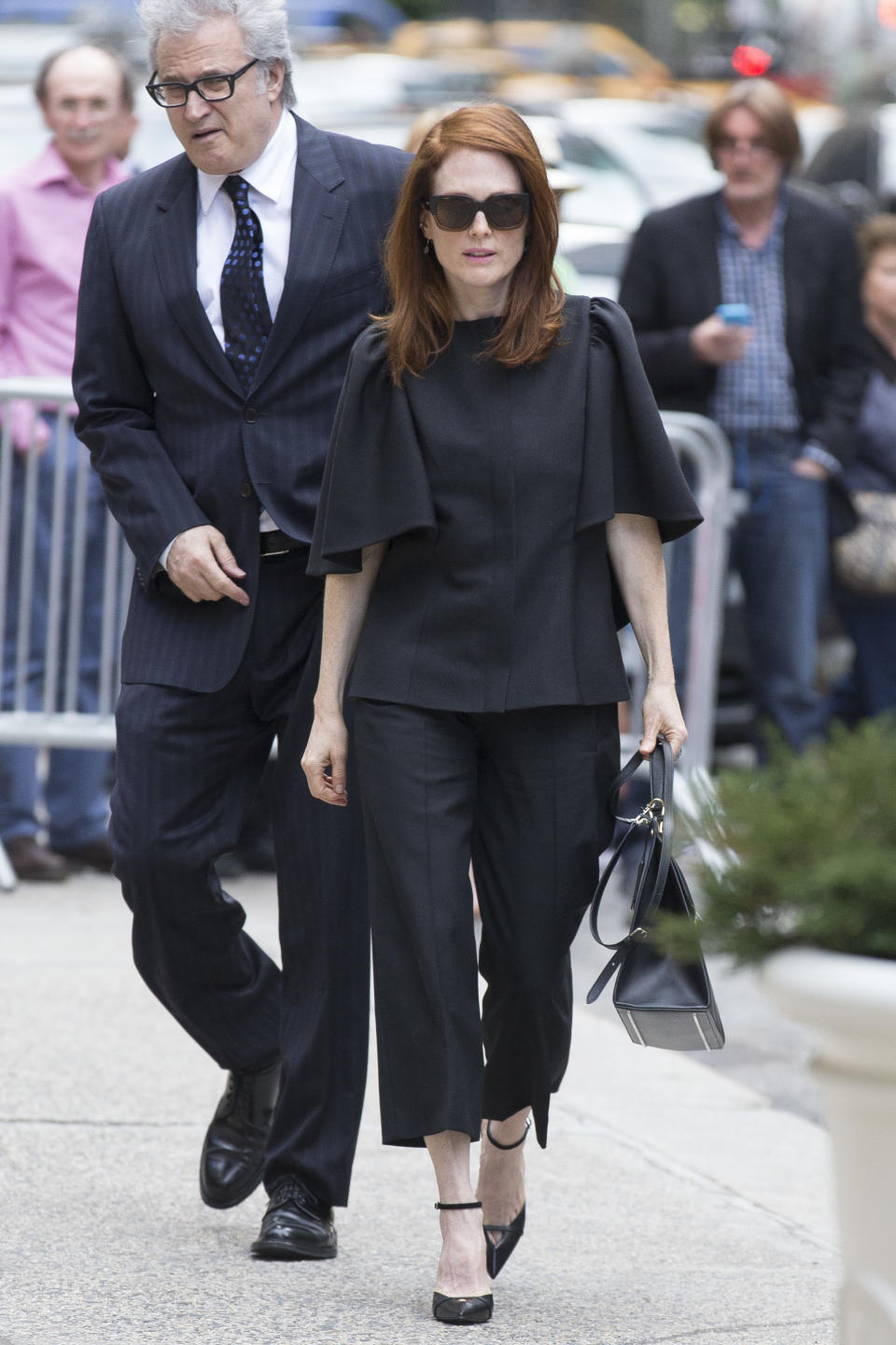 Actress Julianne Moore arrives at St. Bartholomew's Church for a memorial service for fashion designer L'Wren Scott, Friday, May 2, 2014, in New York. Scott committed suicide on March 17 in her Manhattan apartment. (AP Photo/John Minchillo)