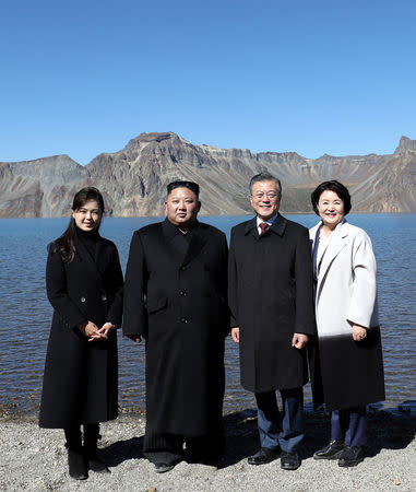 South Korean President Moon Jae-in, first lady Kim Jung-sook, North Korean leader Kim Jong Un and his wife Ri Sol Ju pose for a photograph beside the Heaven Lake of Mt. Paektu, North Korea, September 20, 2018. Pyeongyang Press Corps/Pool via REUTERS