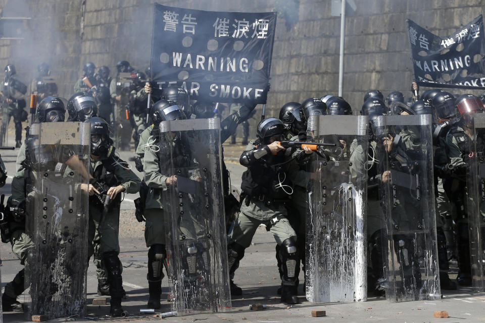 Police prepare to fire on protestors at the Hong Kong Polytechnic University in Hong Kong, Sunday, Nov. 17, 2019. (AP Photo/Achmad Ibrahim)