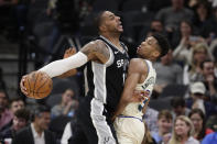 San Antonio Spurs center LaMarcus Aldridge, left, drives against Milwaukee Bucks forward Giannis Antetokounmpo, right, during the second half of an NBA basketball game in San Antonio, Monday, Jan. 6, 2020. (AP Photo/Eric Gay)