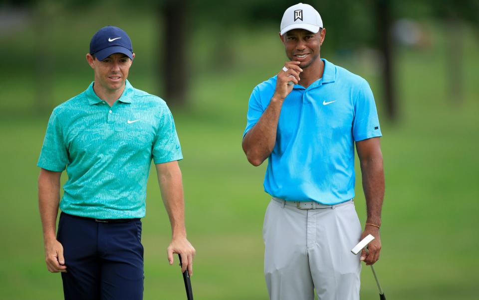 Rory McIlroy of Northern Ireland talks to Tiger Woods of the United States on the tenth green during the first round of The Memorial Tournament - Andy Lyons/Getty Images