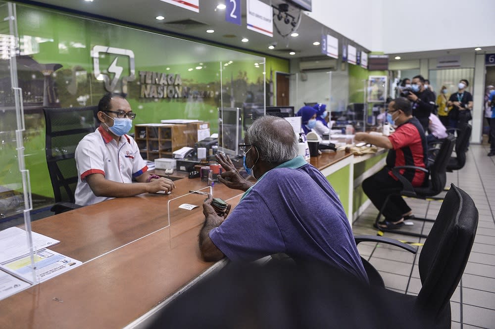 Customers paying their bills at the Shah Alam Kedai Tenaga branch June 2, 2020. — Picture by Miera Zulyana