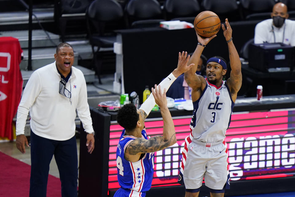 Washington Wizards' Bradley Beal, right, goes up for a shot against Philadelphia 76ers' Danny Green during the second half of Game 5 in a first-round NBA basketball playoff series, Wednesday, June 2, 2021, in Philadelphia. (AP Photo/Matt Slocum)