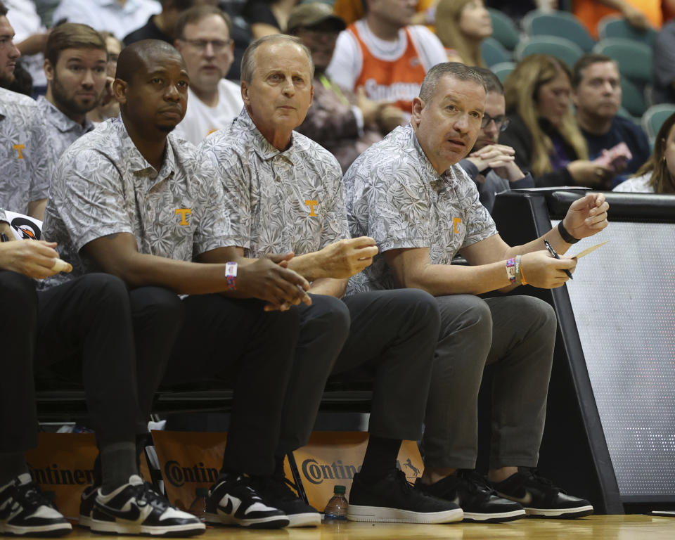 Tennessee head coach Rick Barnes, center, and his staff watch his team take on Syracuse during the first half of an NCAA college basketball game, Monday, Nov. 20, 2023, in Honolulu. (AP Photo/Marco Garcia)