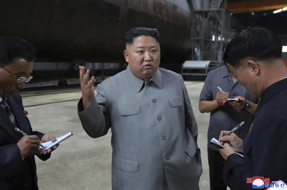 FILE - In this undated file photo provided on Tuesday, July 23, 2019, by the North Korean government, North Korean leader Kim Jong Un, center, speaks while inspecting a newly built submarine to be deployed soon, at an unknown location in North Korea. North Korea fired two unidentified projectiles into the sea on Thursday, July 25, South Korea's military said, the first launches in more than two months as North Korean and U.S. officials work to restart nuclear diplomacy. Independent journalists were not given access to cover the event depicted in this image distributed by the North Korean government. The content of this image is as provided and cannot be independently verified. Korean language watermark on image as provided by source reads: "KCNA" which is the abbreviation for Korean Central News Agency. (Korean Central News Agency/Korea News Service via AP, File)