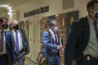 FILE - In this March 25, 2021, file photo Georgia Gov. Brian Kemp, second from right, leaves the Georgia State Capitol Building after he signed into law a sweeping Republican-sponsored overhaul of state elections that includes new restrictions on voting by mail and greater legislative control over how elections are run in Atlanta. (Alyssa Pointer/Atlanta Journal-Constitution via AP, File)