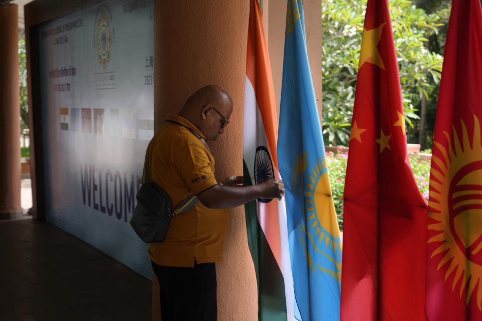 An official adjusts Indian flag at the main venue of the Shanghai Cooperation Organization (SCO) council of foreign ministers' meeting, in Goa, India, Thursday, May 4, 2023. India's foreign minister is expected to hold bilateral talks with counterparts from China and Russia on Thursday ahead of a Central Asian security forum meeting. Foreign ministers of the Shanghai Cooperation Organization began arriving in host India's tourist hotspot Goa, where they are expected to discuss deepening economic and security cooperation in the region on Friday. (AP Photo/Manish Swarup)