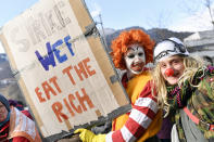 Participants of the climate protest march gather at the train station in Landquart, Switzerland, Sunday, Jan. 19, 2020. Around 500 activists came together to hike the 40 kilometers to Davos to protest against climate change and global warming next Tuesday. (Walter Bieri/Keystone via AP)