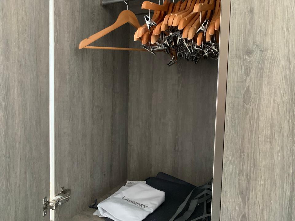 closet on cruise ship with a few hangers inside
