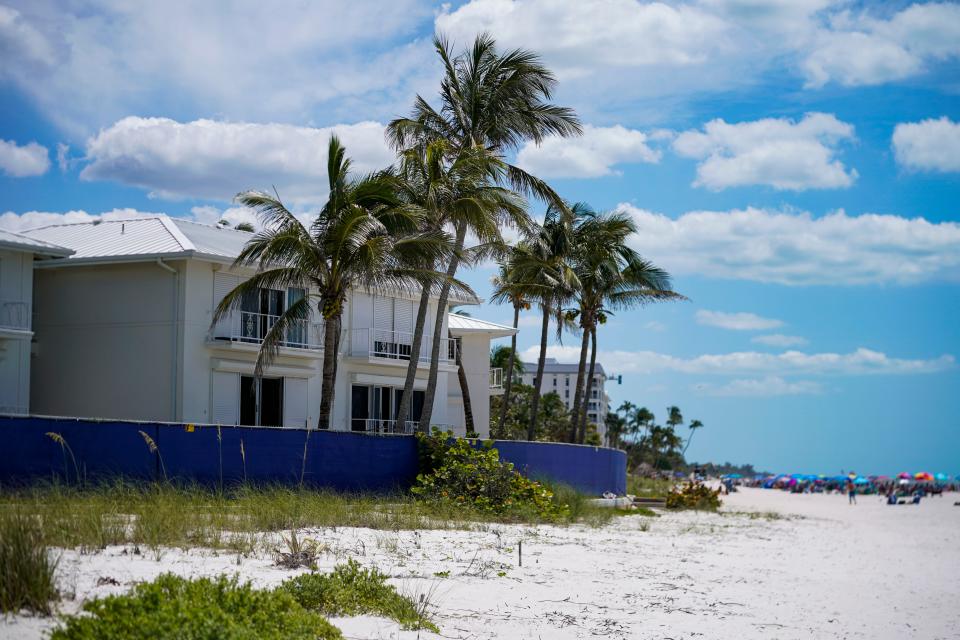 A blue fence surrounds the Mansion House condominiums in Naples on Wednesday, April 19, 2023. The location, 1601 Gulf Shore Blvd. N., will be redeveloped.