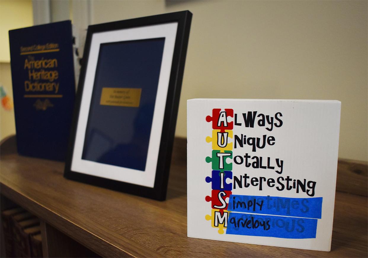 Bookshelves are decorated at the Infinity Library at People, Incorporated on Thursday, Aug. 8, 2024. The library is designed by and for neurodiverse people. Sam Freitas amended the artwork on autism himself.