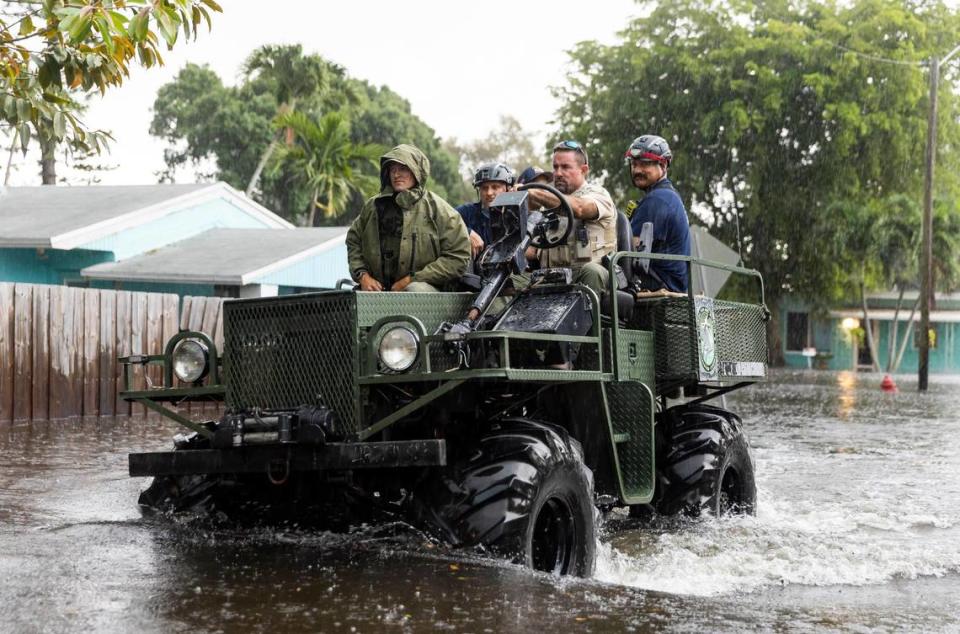 First responders patrol a flooded street in the Edgewood neighborhood on Thursday in Fort Lauderdale. Major roads across Broward County were impassible.