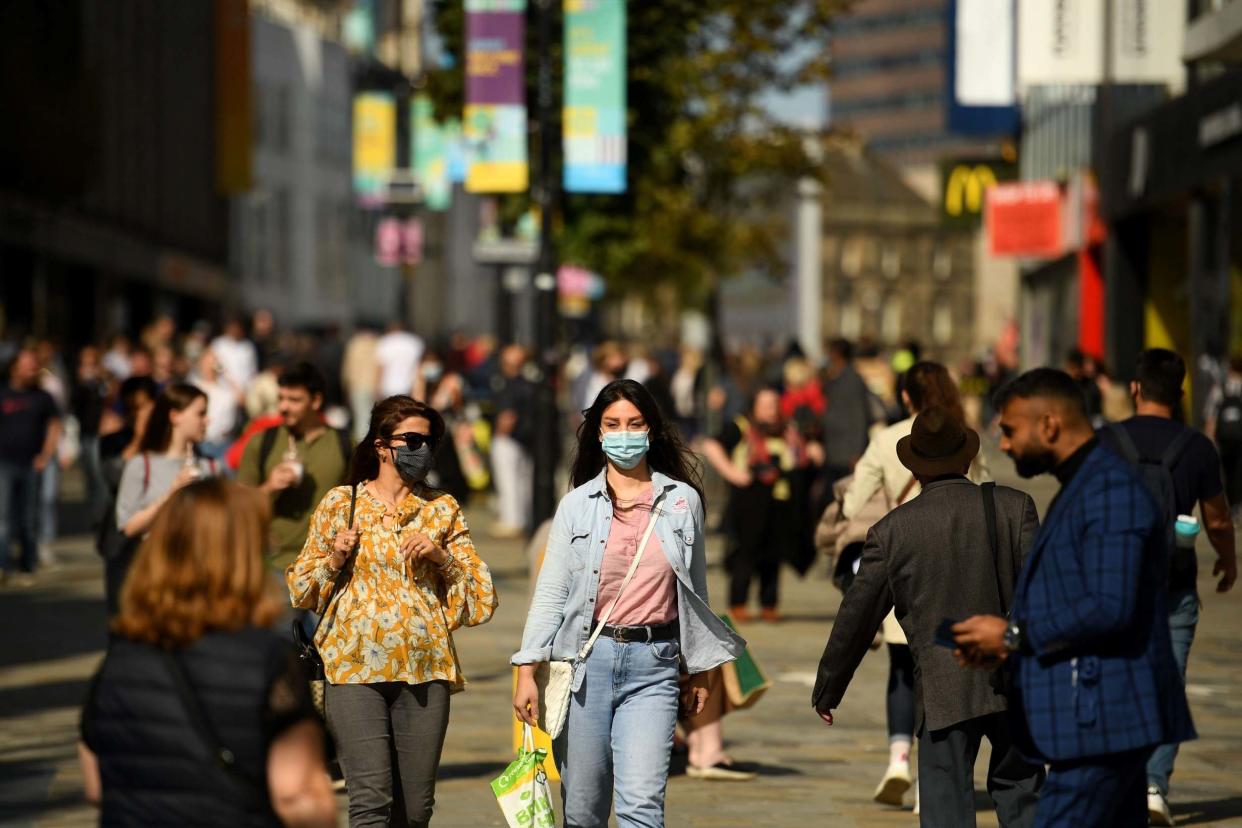 Shoppers walk in Newcastle city centre: AFP via Getty Images