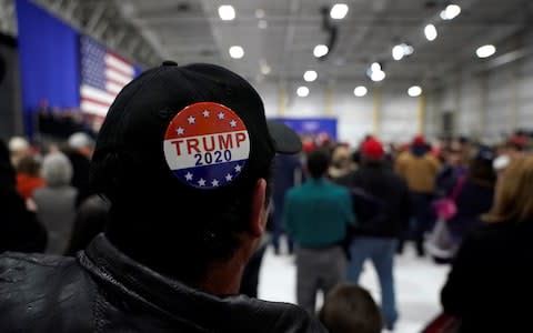 A man wears a Trump 2020 campaign button as U.S. President Donald Trump speaks in Pennsylvania - Credit: Reuters