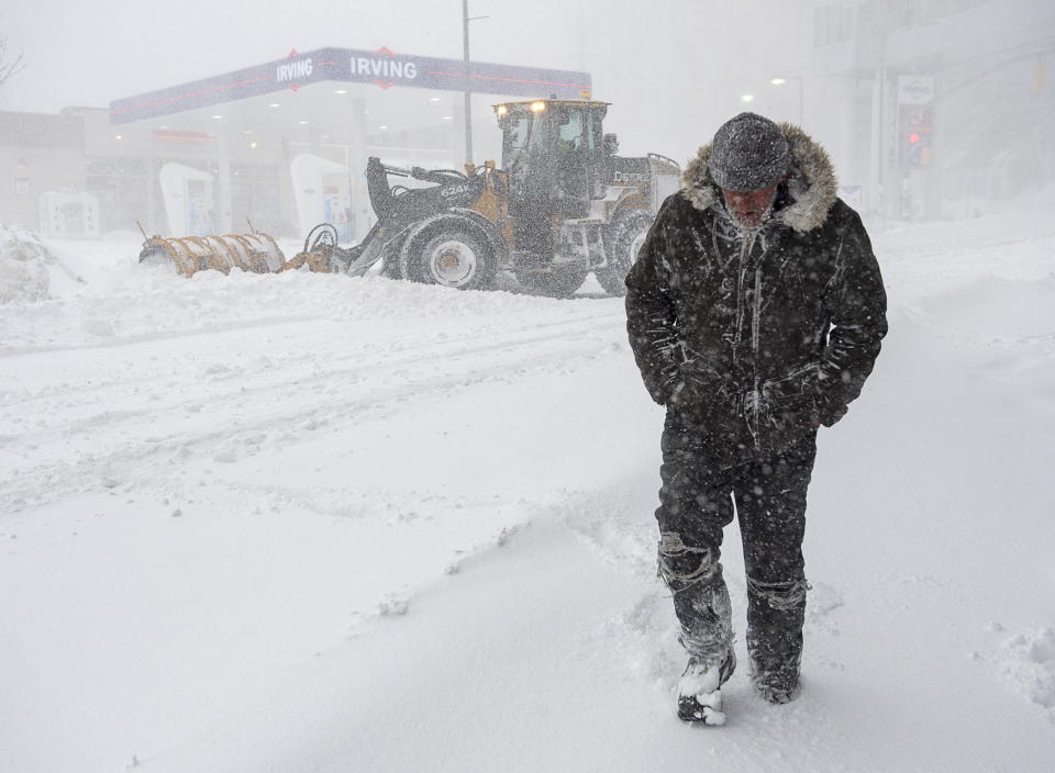 A pedestrian walks through heavy snow in St. John‚ Newfoundland on Friday, Jan. 17, 2020. The city has declared a state of emergency, ordering businesses closed and vehicles off the roads as blizzard conditions descend on the Newfoundland and Labrador capital. *Andrew Vaughan/The Canadian Press via AP)