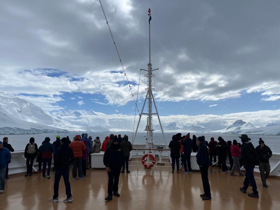 cruisegoers bundled up on a wet deck