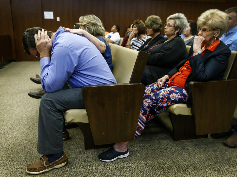 Ben Chambers, father of Jessica Chambers, covers his ears during testimony in the retrial of Quinton Tellis in Batesville, Miss., on Wednesday, Sept. 26, 2018. Tellis is charged with burning 19-year-old Chambers to death in December 2014. Tellis has pleaded not guilty to the murder. (Mark Weber /The Commercial Appeal via AP, Pool)