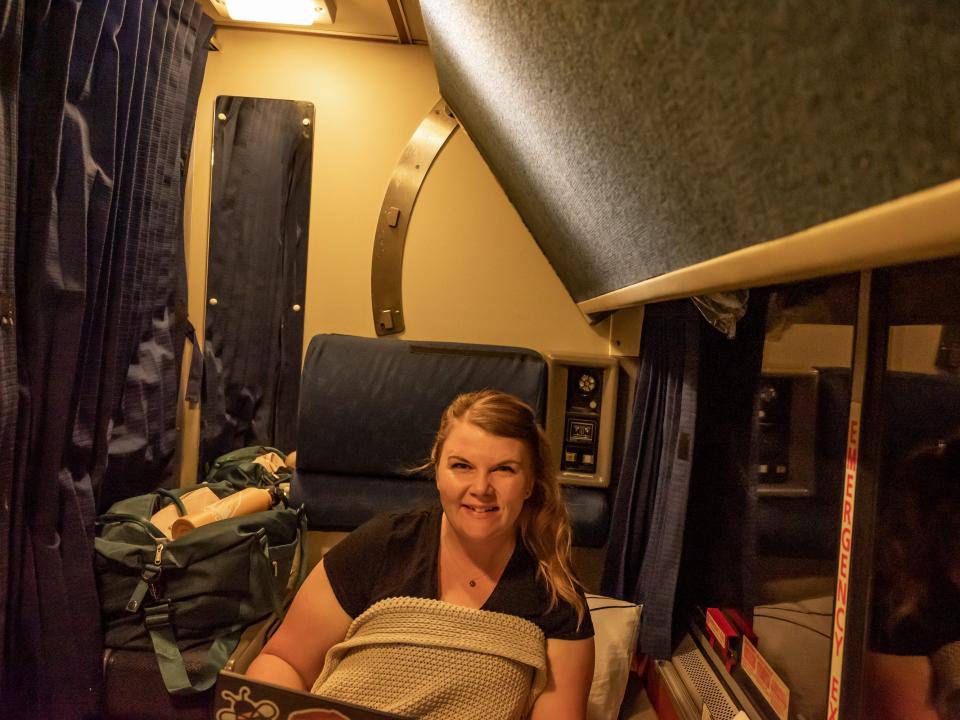 Molly Allen sitting in roomette on coast starlight amtrak train