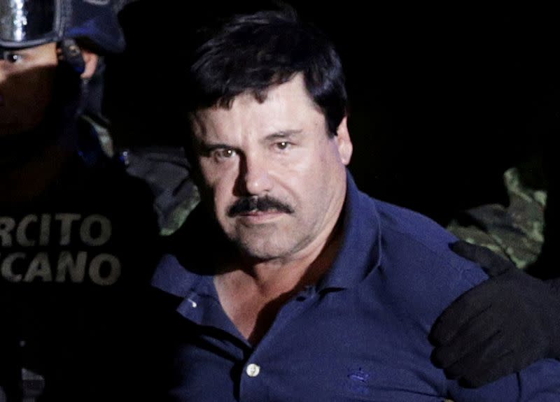 FILE PHOTO: Recaptured drug lord Joaquin "El Chapo" Guzman is escorted by soldiers at the hangar belonging to the office of the Attorney General in Mexico City