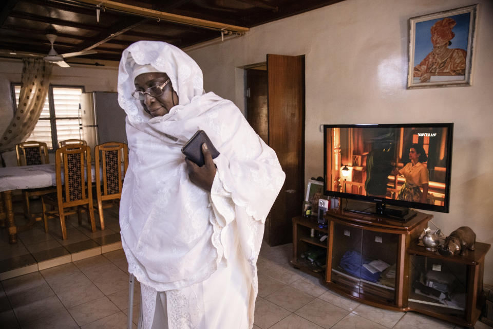 Zenabou Coulibaly Zongo, consultant and founding member of the Council of Burkinabe Women, in her house in Ouagadougou, Burkina Faso, Friday, Oct. 29, 2021. Zongo spends her own money making soap and buying hand sanitizer for mosques, markets and health centers. At the start of the pandemic, Zongo, now 63, was hospitalized with bronchial pneumonia. She paid out of pocket for two weeks' worth of oxygen treatments at a private clinic, where she watched others die from respiratory problems. (AP Photo/Sophie Garcia)