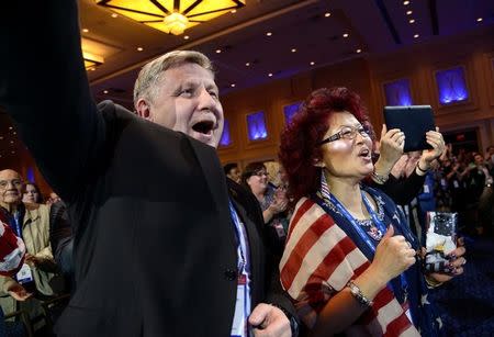 FILE PHOTO - Pennsylvania Congressman Rick Saccone and his wife Yong cheer as they listen to remarks during the opening day of the Conservative Political Action Conference (CPAC), an annual gathering of conservative politicians, journalists and celebrities, at National Harbor, Maryland, U.S., February 22, 2017. REUTERS/Mike Theiler