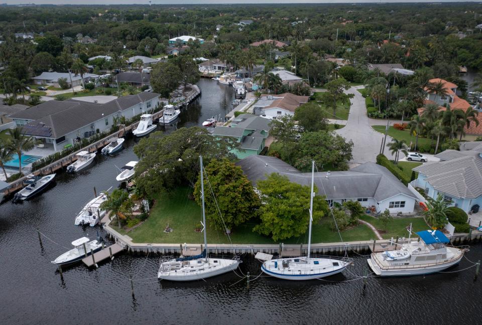 Multiple boats are docked beside homes in the Paradise Port community in Palm Beach Gardens.