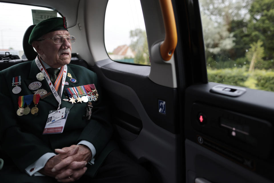 British veteran Richard Forrester of the Kings Royal Rifle Corps arrives in a British Taxi Charity for Military Veterans at the ceremony at Pegasus Bridge, in Ranville, Normandy, Sunday, June, 5, 2022. On Monday, the Normandy American Cemetery and Memorial, home to the gravesites of 9,386 who died fighting on D-Day and in the operations that followed, will host U.S. veterans and thousands of visitors in its first major public ceremony since 2019. (AP Photo/Jeremias Gonzalez)