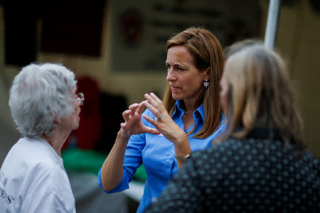 FILE PHOTO: US Democratic congressional candidate Mikie Sherrill (C) speaks with people as she campaigns during the New Jersey State Fair in Augusta, New Jersey, U.S., August 12, 2018. Picture taken on August 12, 2018. REUTERS/Eduardo Munoz/File Photo