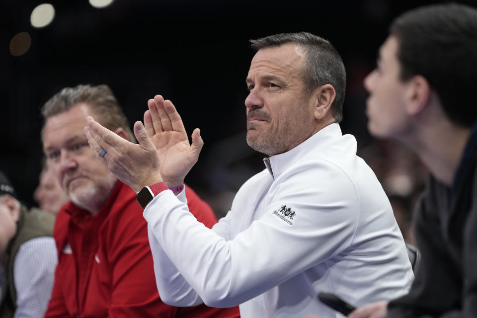 Louisville women's basketball coach Jeff Walz, applauds as he watches Louisville men's team play against North Carolina State during the first half of the Atlantic Coast Conference NCAA college basketball tournament Tuesday, March 12, 2024, in Washington. (AP Photo/Susan Walsh)