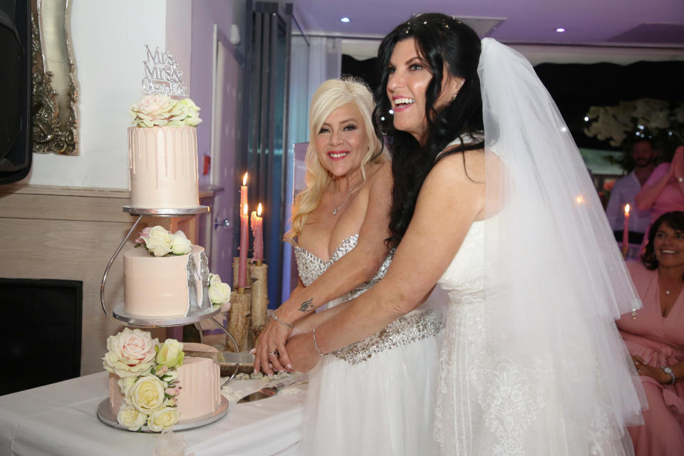 Samantha Fox and Linda Birgitte Olsen cut their wedding cake. (Fox Media via Getty Images )