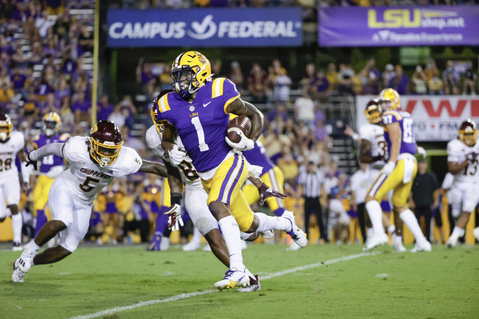 LSU wide receiver Kayshon Boutte (1) runs past Central Michigan linebacker Troy Brown (8) and defensive back Devonni Reed (5) for a touchdown during the second quarter of an NCAA college football game in Baton Rouge, La,. Saturday, Sept. 18, 2021. (AP Photo/Derick Hingle)