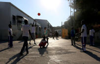 Immigrants play in a refugee centre in Lampedusa, Italy July 8, 2013. REUTERS/Alessandro Bianchi/File Photo