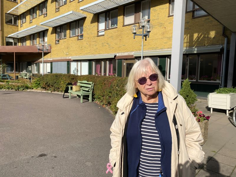 Ingrid Bolander poses for a photo on her way to visit husband admitted to the care facility, in Gothenburg