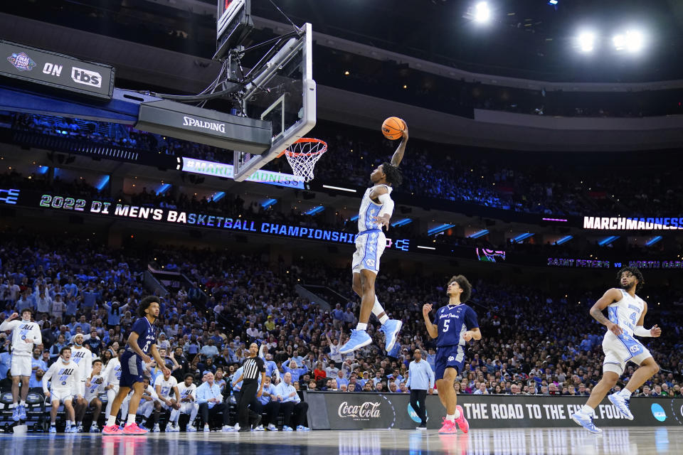 North Carolina's Caleb Love goes for a dunk during the second half of a college basketball game against St. Peter's in the Elite 8 round of the NCAA tournament, Sunday, March 27, 2022, in Philadelphia. (AP Photo/Matt Rourke)