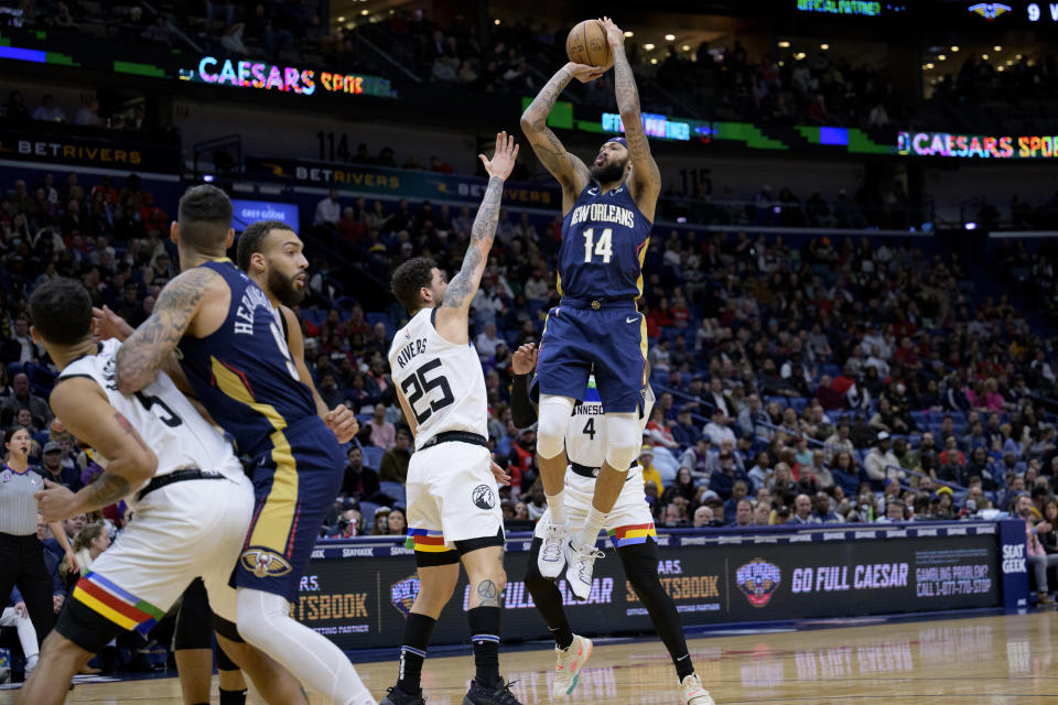 New Orleans Pelicans forward Brandon Ingram (14) shoots over Minnesota Timberwolves guard Austin Rivers (25) during the first half of an NBA basketball game in New Orleans, Wednesday, Jan. 25, 2023. (AP Photo/Matthew Hinton)