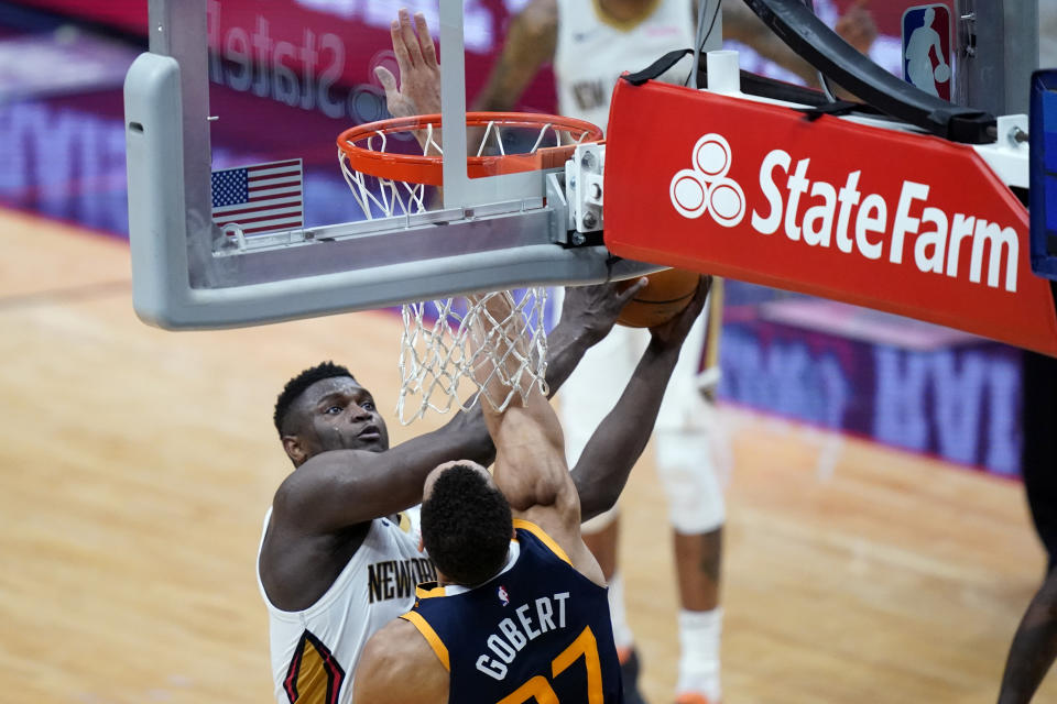 New Orleans Pelicans forward Zion Williamson shoots against Utah Jazz center Rudy Gobert in the first half of an NBA basketball game in New Orleans, Monday, March 1, 2021. (AP Photo/Gerald Herbert)