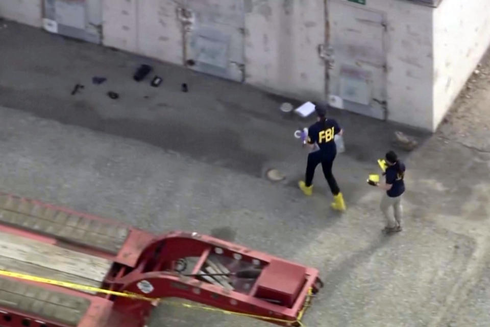 In this image taken from video provided by KTLA, law enforcement personnel work at the scene following an explosion during an indoor training exercise, Wednesday, March 13, 2024, in Irvine, Calif. An explosion during an indoor training exercise Wednesday sent 16 members of Southern California's Orange County Sheriff’s Department SWAT team to the hospital, with one person requiring surgery for a leg injury, the department said. (KTLA via AP)