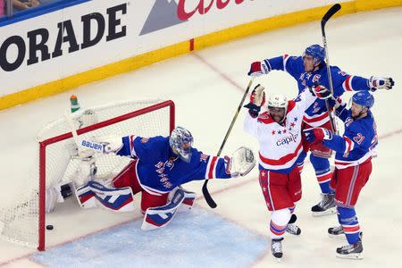 May 8, 2015; New York, NY, USA; Washington Capitals right wing Joel Ward (42) interferes with New York Rangers goalie Henrik Lundqvist (30) in front of New York Rangers center Derek Stepan (21) and New York Rangers defenseman Ryan McDonagh (27) and the referees rule no goal during the second period of game five of the second round of the 2015 Stanley Cup Playoffs at Madison Square Garden. Mandatory Credit: Brad Penner-USA TODAY Sports
