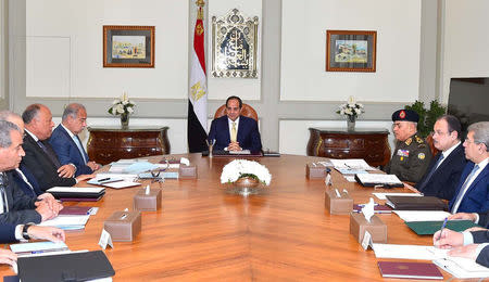 Egyptian President Abdel Fattah al-Sisi (C) meets with his prime Minister Sherif Ismail (4th L) with other ministers and senior State officials at the Ittihadiya presidential palace in Cairo, Egypt March 13, 2017 in this handout picture courtesy of the Egyptian Presidency. The Egyptian Presidency/Handout via REUTERS