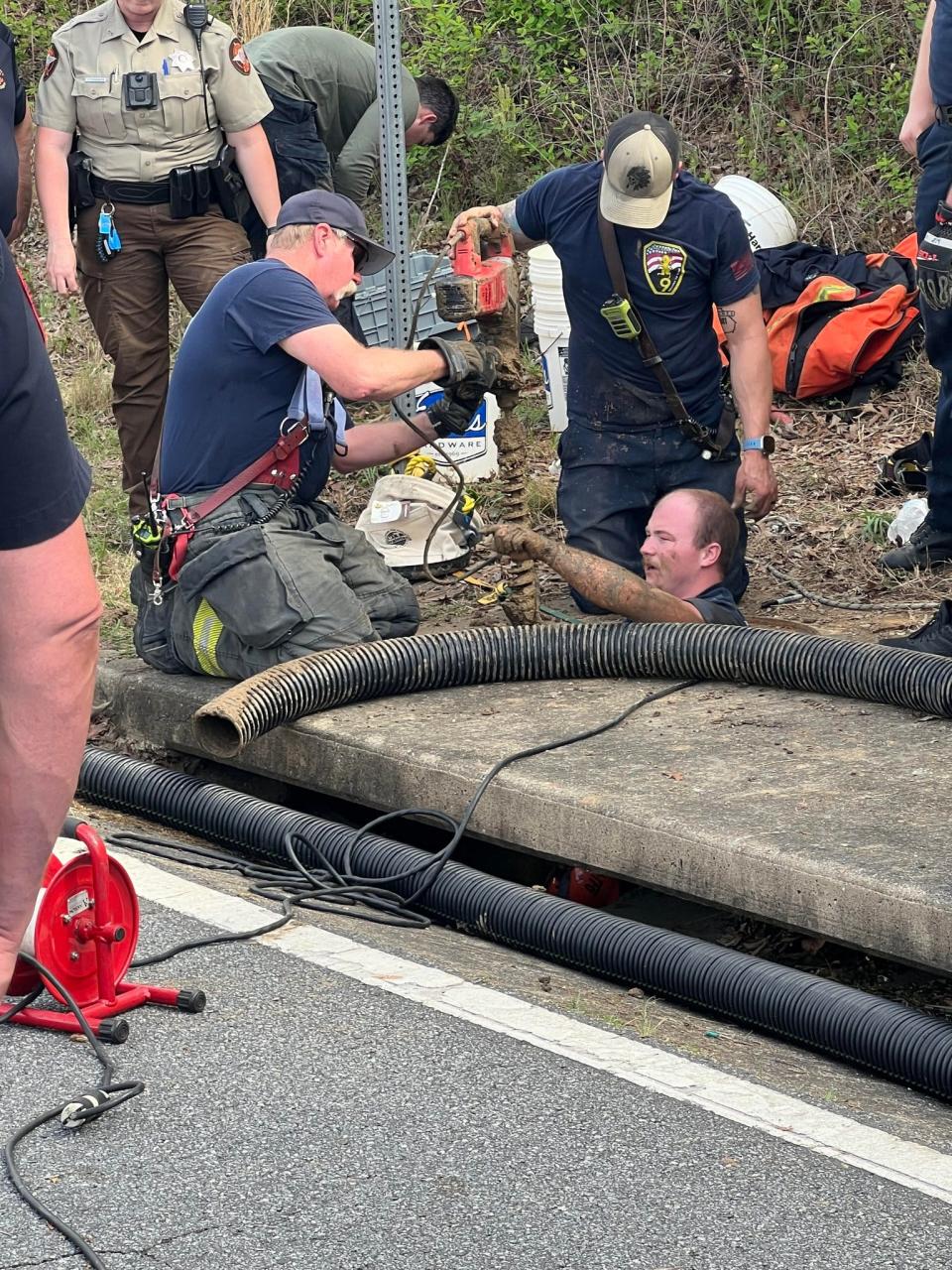 Various first responders work to rescue a 22-year-old man, who was trapped in a storm drain in Fort Oglethorpe, Ga. on Tuesday, April 16, 2024.