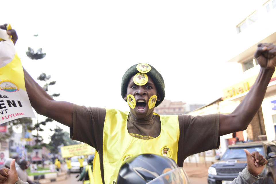 A supporter of Ugandan President Yoweri Kaguta Museveni celebrates, in Kampala, Uganda, Saturday Jan. 16, 2021, after their candidate was declared winner of the presidential elections. Uganda’s electoral commission says longtime President Yoweri Museveni has won a sixth term, while top opposition challenger Bobi Wine alleges rigging and officials struggle to explain how polling results were compiled amid an internet blackout. In a generational clash widely watched across the African continent, the young singer-turned-lawmaker Wine posed arguably the greatest challenge yet to Museveni. (AP Photo/Nicholas Bamulanzeki)