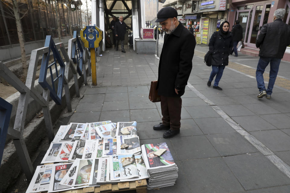 A man scans front pages of Iranian newspapers at a news stand with pictures of Iranian Revolutionary Guard Gen. Qassem Soleimani, who was killed in a U.S. airstrike early Friday in Iraq, in Tehran, Iran, Saturday, Jan. 4, 2020. (AP Photo/Vahid Salemi)