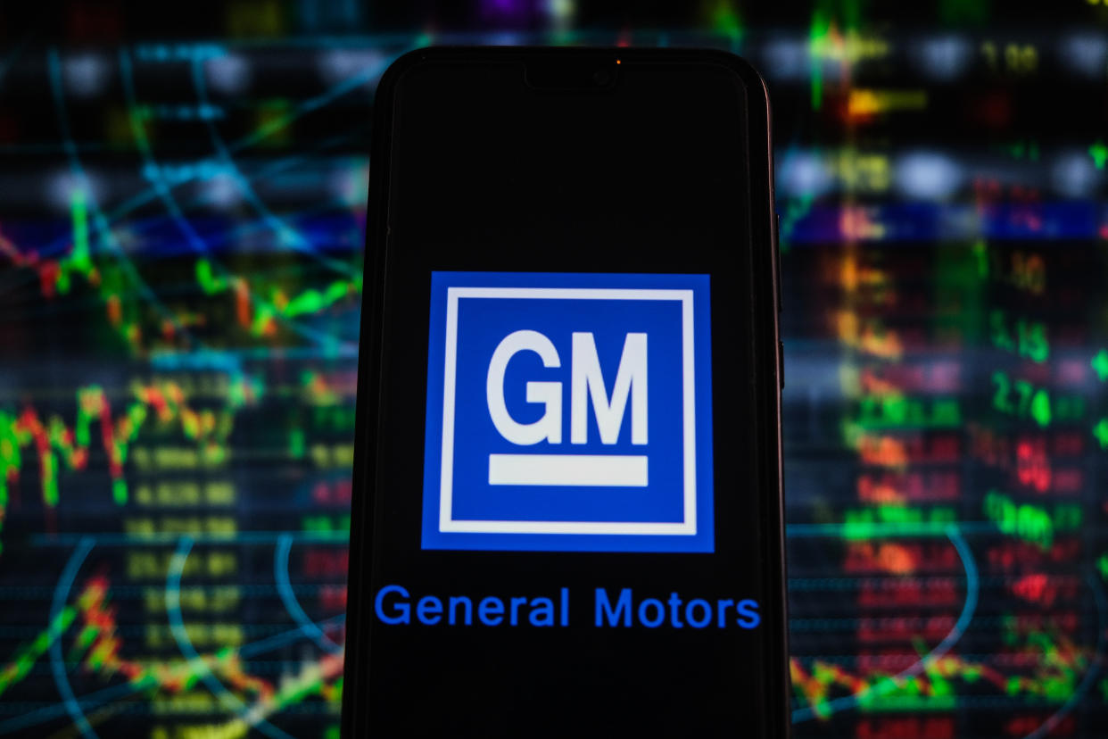 POLAND - 2021/04/26: In this photo illustration a General Motors logo seen displayed on a smartphone with stock market percentages in the background. (Photo Illustration by Omar Marques/SOPA Images/LightRocket via Getty Images)