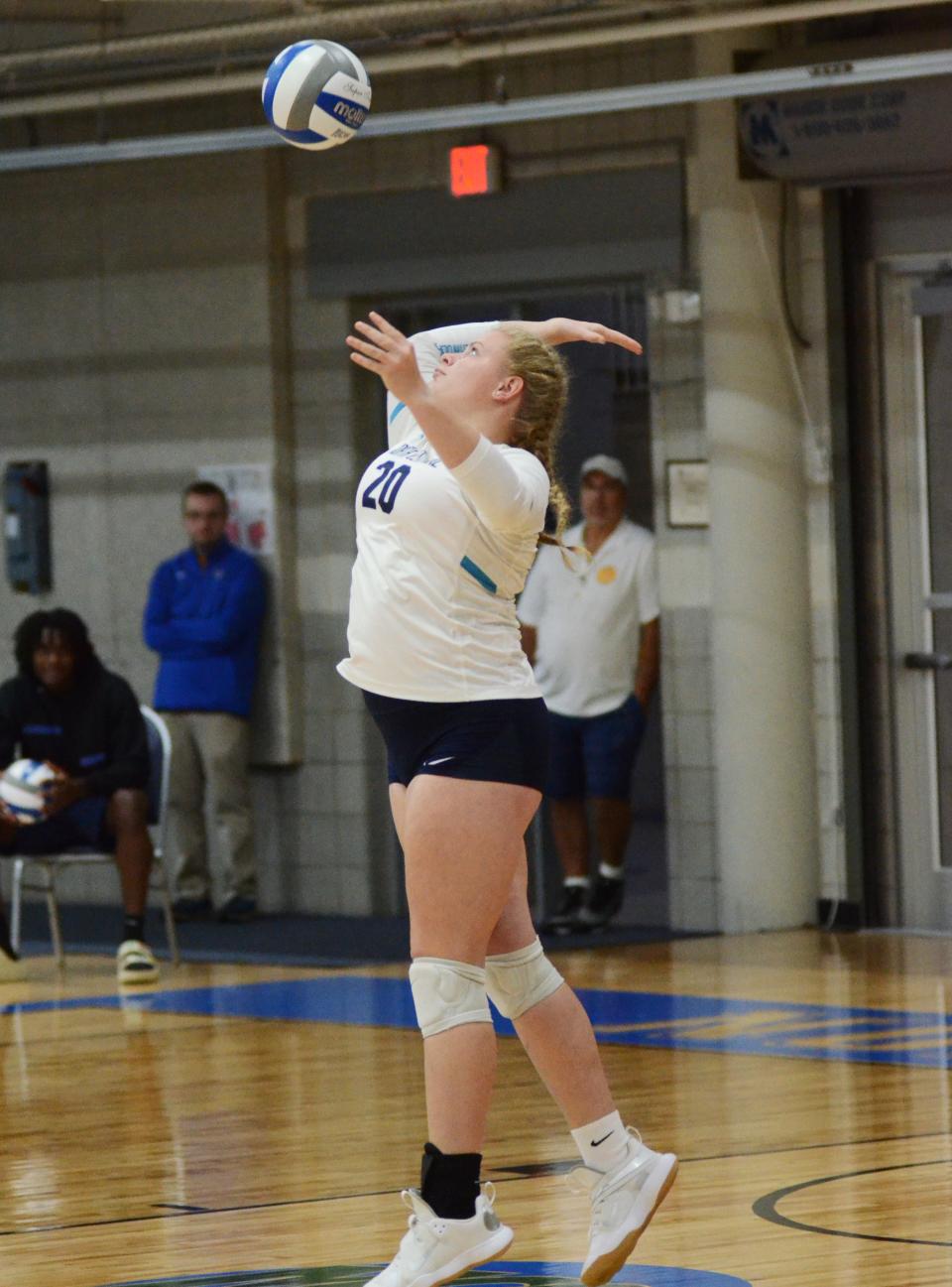 North Central's Maggie Nelson serves against Muskegon Thursday.