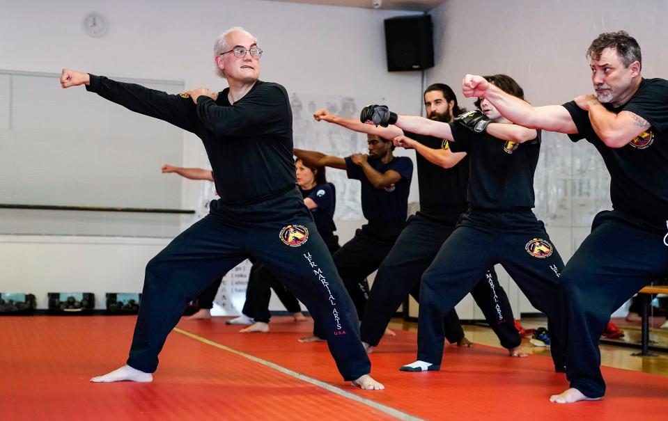 UFR Martial Arts instructor Ulises Rodriguez demonstrates a move with his students Wednesday, June 14, 2023, during a martial arts class at UFR Martial Arts in Indianapolis. 