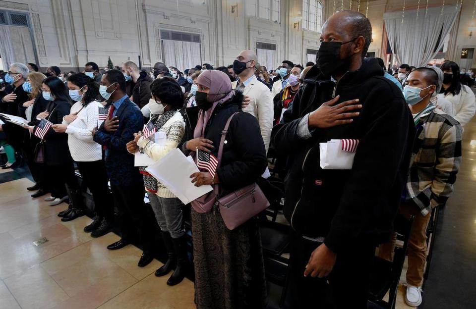 During the first naturalization ceremony to be hosted at Union Station, Hassan Heydhow, front right, was one of 250 people that were sworn in as new U.S. citizens by U.S. Citizenship and Immigration Services and the U.S. District Court of Western Missouri. Heydhow came to the United States from Somalia. The group stood for the Pledge of Allegiance at the conclusion of the ceremony. The new U.S. citizens came from 61 countries.